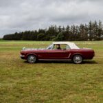 Cabriolet ancien rouge sur une route de campagne