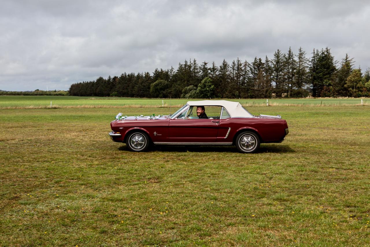 Cabriolet ancien rouge sur une route de campagne